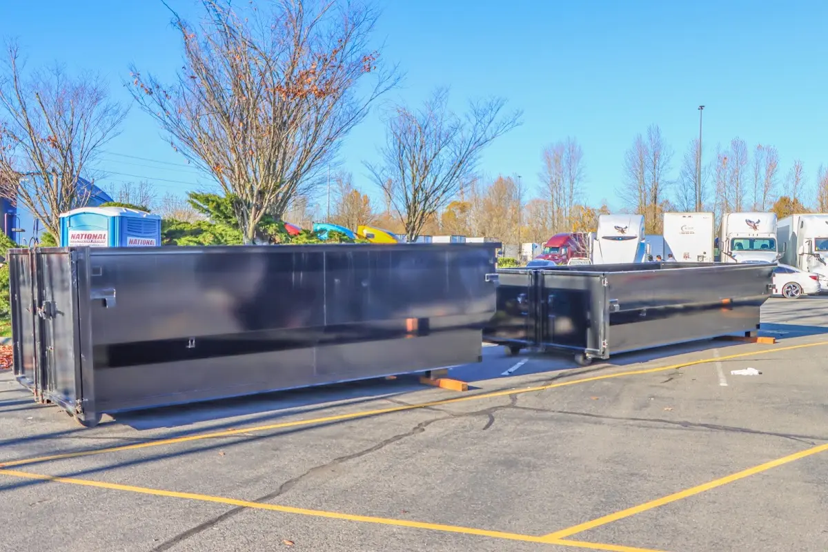 Professional dumpster rental service with roll-off container on residential driveway in Petoskey